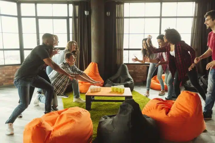 A group photo of a bunch of people laughing over a drinking game, used as a metaphor for nonprofit donation form optimization!