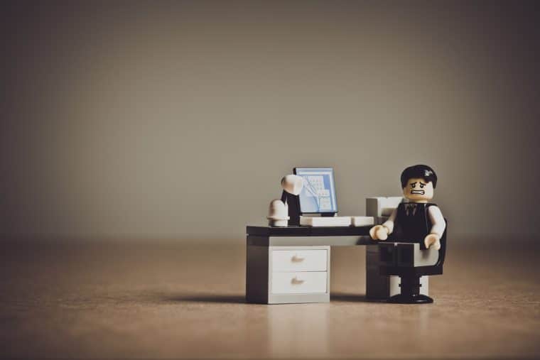 A lego business character sits at a desk with a computer and a frazzled expression on its face. What to do when your website goes down.