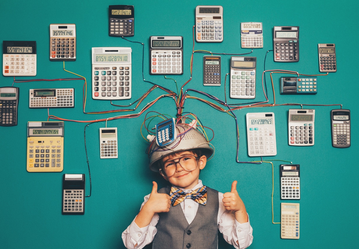 A young boy dressed as a stereotypical nerd is giving two thumbs up and wearing a pretend helmet and calculator invention that we're sure helps him process google analytics for nonprofits!