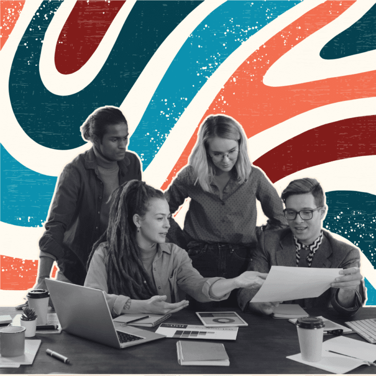 A group of people looking over papers and computers