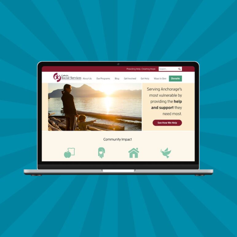 A laptop displaying a nonprofit web design for Catholic Social Services, featuring an image of two people by a lake at sunset and sections about community impact, ways to help, and program information. Blue radial background behind the laptop.