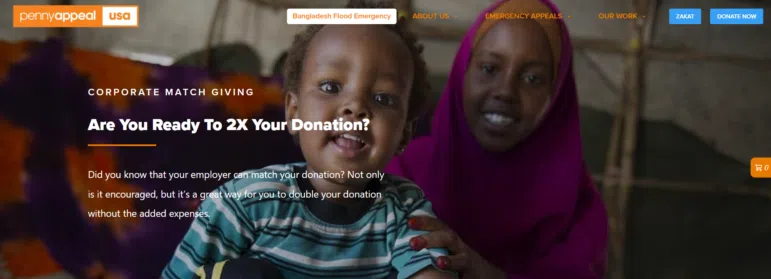 A smiling woman in a pink headscarf sits behind a happy young child indoors. The website banner promotes doubling donations, with text and navigation links visible at the top.